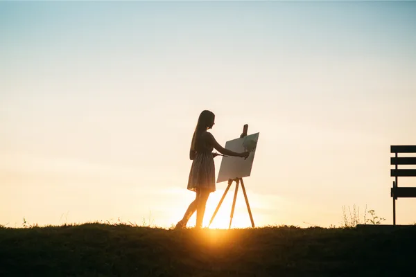 外で絵を描く女性